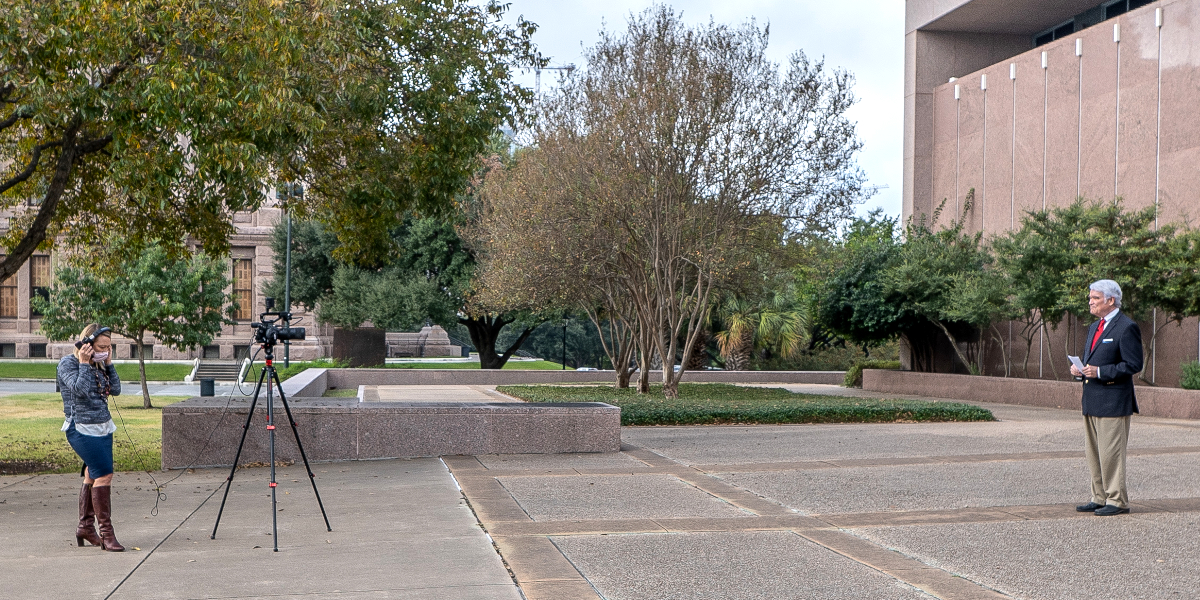 Photo of a videographer recording Chief Hecht in front of the Tom C. Clarke building