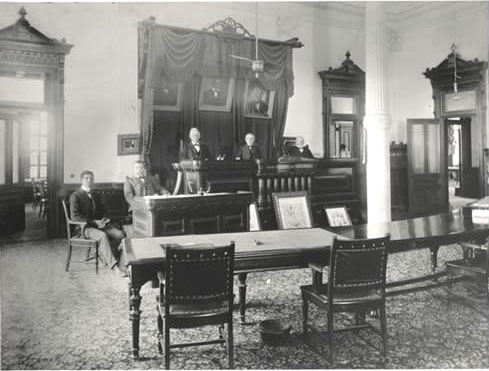 Deputy Clerk F. T. Connerly, Clerk Charles S. Morse, with Court. Undated. Photo: Austin History Center.